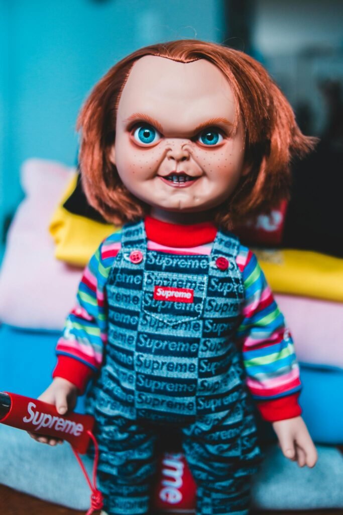 Chucky-inspired doll in Supreme streetwear, perfect for fashion and horror themes.