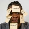 Creative representation of brainstorming ideas with sticky notes on man's face for innovation and planning.