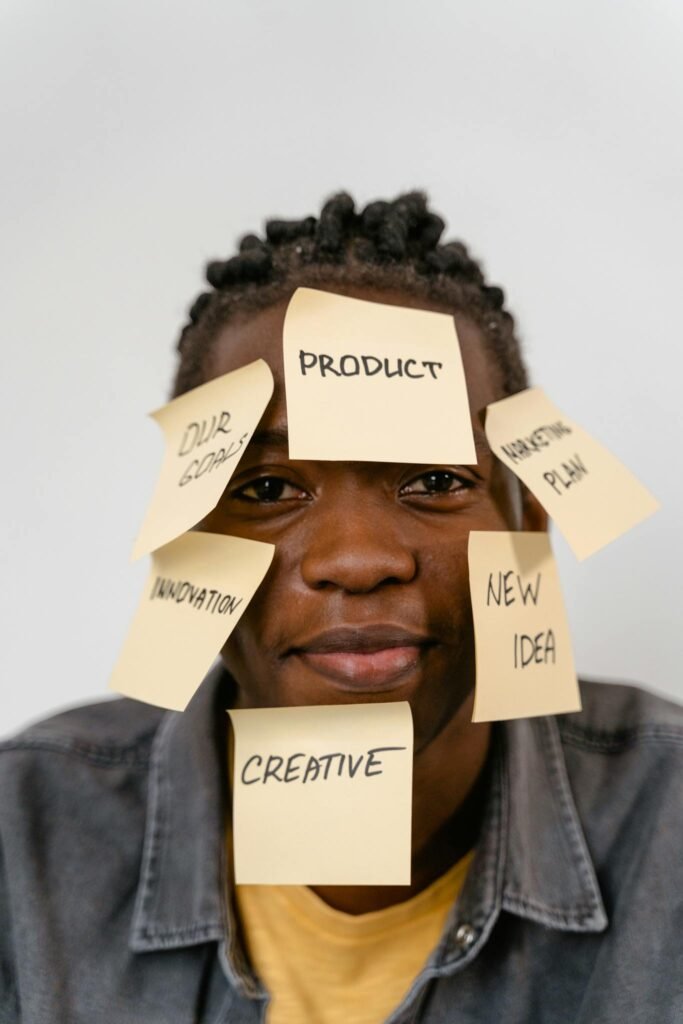 Creative representation of brainstorming ideas with sticky notes on man's face for innovation and planning.